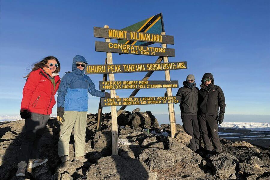 a group of people standing in front of a sign